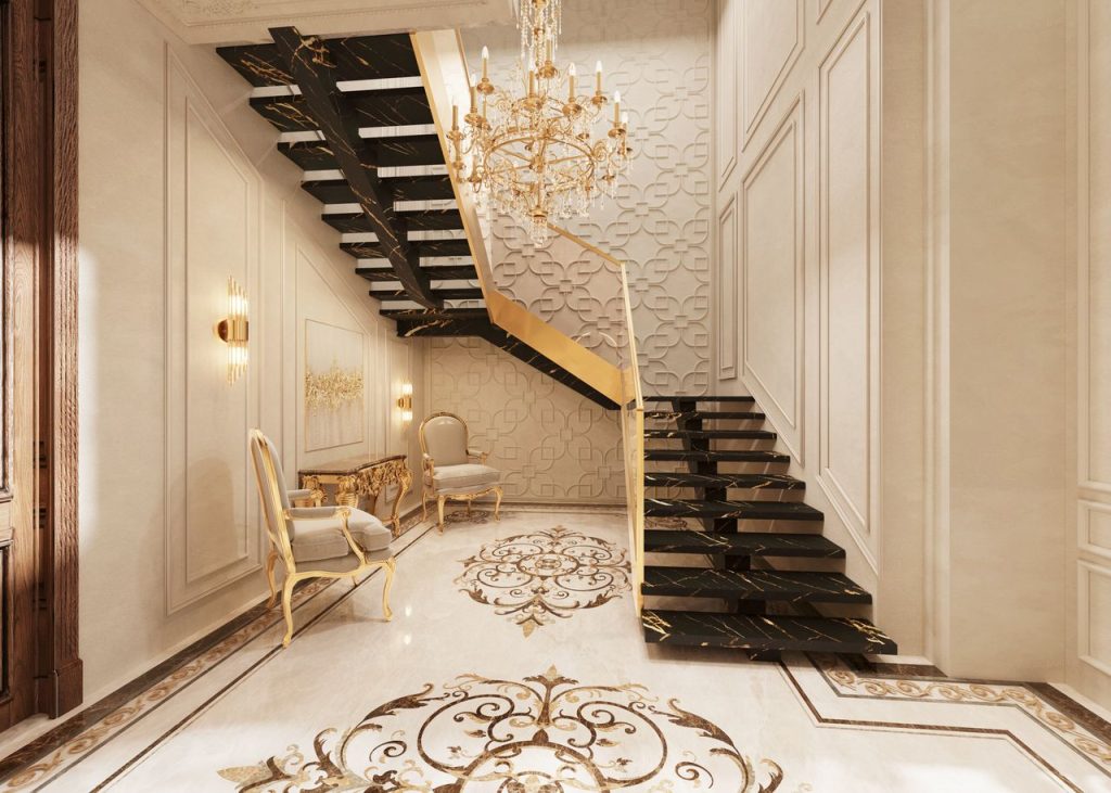 Richly designed baroque interior with ornate staircase and chandelier, exuding opulence.