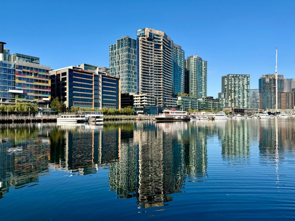 Modern skyscrapers reflecting on the tranquil water in Docklands, Victoria, Australia.